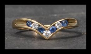 A hallmarked 9ct gold blue sapphire and diamond wishbone ring. Diamonds approx 10pts total.