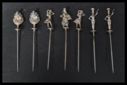 A set of six unusual silver white metal cocktail sticks / skewers with dancing girl finials. Various