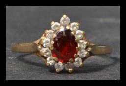 A hallmarked 9ct gold ring set with a central oran