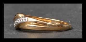 A hallmarked 9ct gold and diamond crossover band r