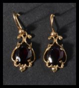 A pair of 9ct gold and amethyst earrings. Hallmark
