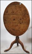 A 19th century Georgian oak tilt top table of circ