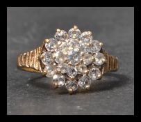 A hallmarked 9ct gold and white stone cluster ring
