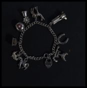 A hallmarked 925 silver charm bracelet having char