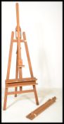 A 20th Century large wooden folding artists easel stand together with a similar one of smaller