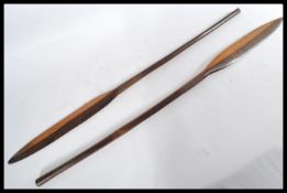 A pair of vintage 20th century African Tribal spears of wooden construction having cylindrical