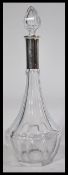 A continental silver hallmarked collared cut glass decanter having faceted glass sides with bullet
