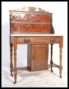An Edwardian Art Nouveau walnut and marble tile back washstand. The white marble top over a single