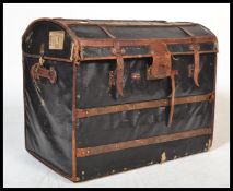 A 19th century Victorian canvas and wooden bound dome top steamer trunk. Black canvas with wooden