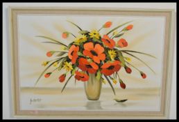 A 20th century oil on canvas painting of a vase of flowers. The vibrant colours with artist