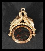 An early 20th century 9ct gold swivel fob having a bloodstone and chalcedony set fob surmounted by