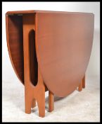 A large retro 20th century G-Plan teak drop leaf dining table having shaped supports, the end leaves