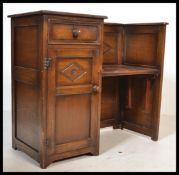 A good Ipswich oak hall settle bench having a flared top with drop centre seat over linen fold