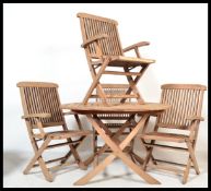 A good quality teak wood garden table and chairs - patio suite. The circular table and chairs all
