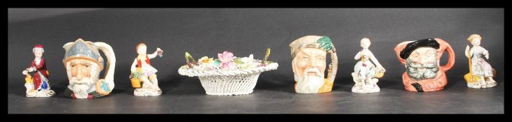 A group of four Sitzendorf ceramic figures along with three Royal Doulton Character jugs and a Crown