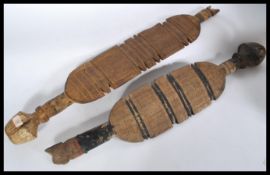 A pair of tribal Africal ceremonial staffs having carved and chased detailing to each staff with