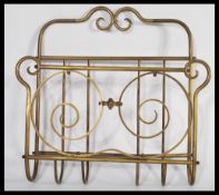 A 19th century Victorian brass wall mounted letter rack / magazine Canterbury of scrolled tubualr