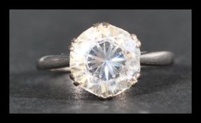An 18ct white gold and platinum ring set with a large white stone. Marked 18ct and Plat. Tests