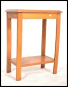 An early 20th Century Art Deco walnut side table / console table, raised on square moulded