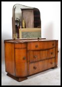 A 20th century walnut Art Deco dressing table, having a series of drawers with mirror atop raised on