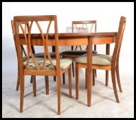 G-Plan - A retro 1960's teak wood extending dining table of round form raised on tapering legs