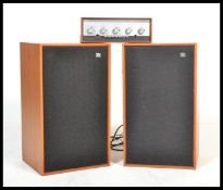 A vintage pair of Wharfdale dovedale 3 speakers in a teak wood finish, together with a Leak ' stereo