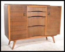 A 1970's beehive front oak veneer sideboard cabinet by Avalon of Yatton. Raised on tapered