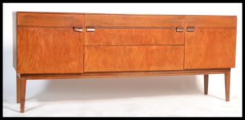 A 1970's Danish teak wood sideboard being raised on tapered legs with a series of drawers and