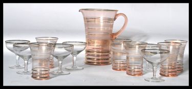 A retro mid century lemonade set in flash ruby glass with jug and glasses having banded design