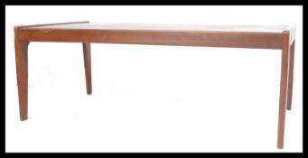 A 1970's teak wood Komfort Danish large coffee - occasional table being raised on tapering leg
