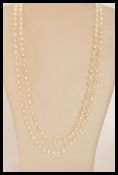 A long baroque pearl necklace chain of graduating bead form.