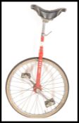 A vintage retro 20th century unicycle bicycle by Pashley having a red painted finish with adjustable