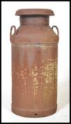 A vintage Industrial dairy milk churn of cylindrical construction with Hornsby Daires  makers name