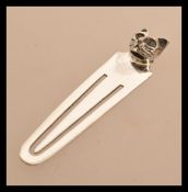 A sterling silver bookmark having a cat head finial. Weighs 3 grams.