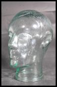 A 20th century moulded pressed glass phrenology type head - shop display stand / millinery mannequin