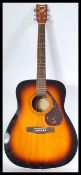 A 20th Century six string acoustic guitar by Yamaha, applied paper label reading Yamaha F370 TBS