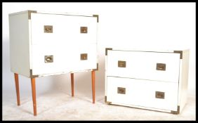 A pair of retro 20th Century campaign style chest of drawers, each with three long drawers with