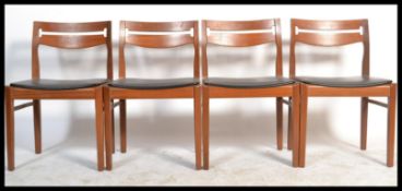 A retro mid century teak wood set of  Nathan dining room  chairs with pierced railed back rests