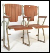 A vintage 20th centurty industrial pair of cinema chairs on tubular metal frame' wooden back rest