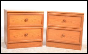 A pair of 20th century teak wood G-Plan bedside cabinet chests, each raised on plinth bases with