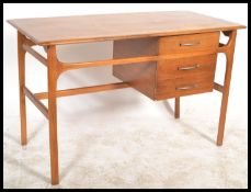 A vintage retro 20th century Danish Influence teak and beech wood writing desk raised on tapered