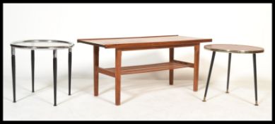 A vintage 20th century teak wood coffee table with magazine rack to underside and edge rails