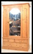 A good quality 20th century antique style pine wardrobe. Plint base with drawers having upright robe