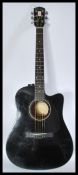 A 20th Century electro - acoustic six string ebonised  guitar by Fender applied paper label to