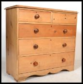 A Victorian country pine 2 over 3 chest of drawers. Raised on bun feet the short and deep graduating
