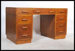 A 1930's oak twin pedestal office desk in the mann