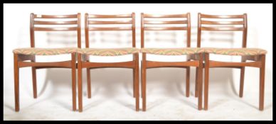 A set of 4 mid century Danish influence teak wood dining chairs. Raised on squared legs with pad