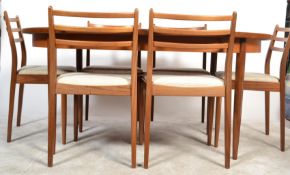 A 1970's G-Plan Sienna range teak wood extending dining table and chairs suite. The table being