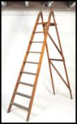 A 20th century large vintage wooden step ladder. Measures: 250xm high x 58cm wide.