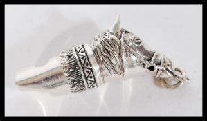 Equestrian Horse Racing interest. A sterling silver horse head whistle being stamped 925.